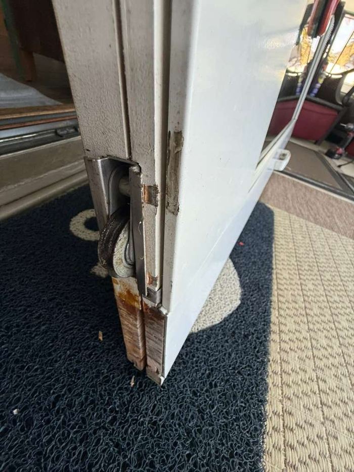 Close-up of a worn sliding door roller removed during a Tampa repair