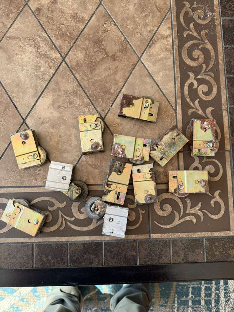 New sliding door rollers laid out before installation in Tampa